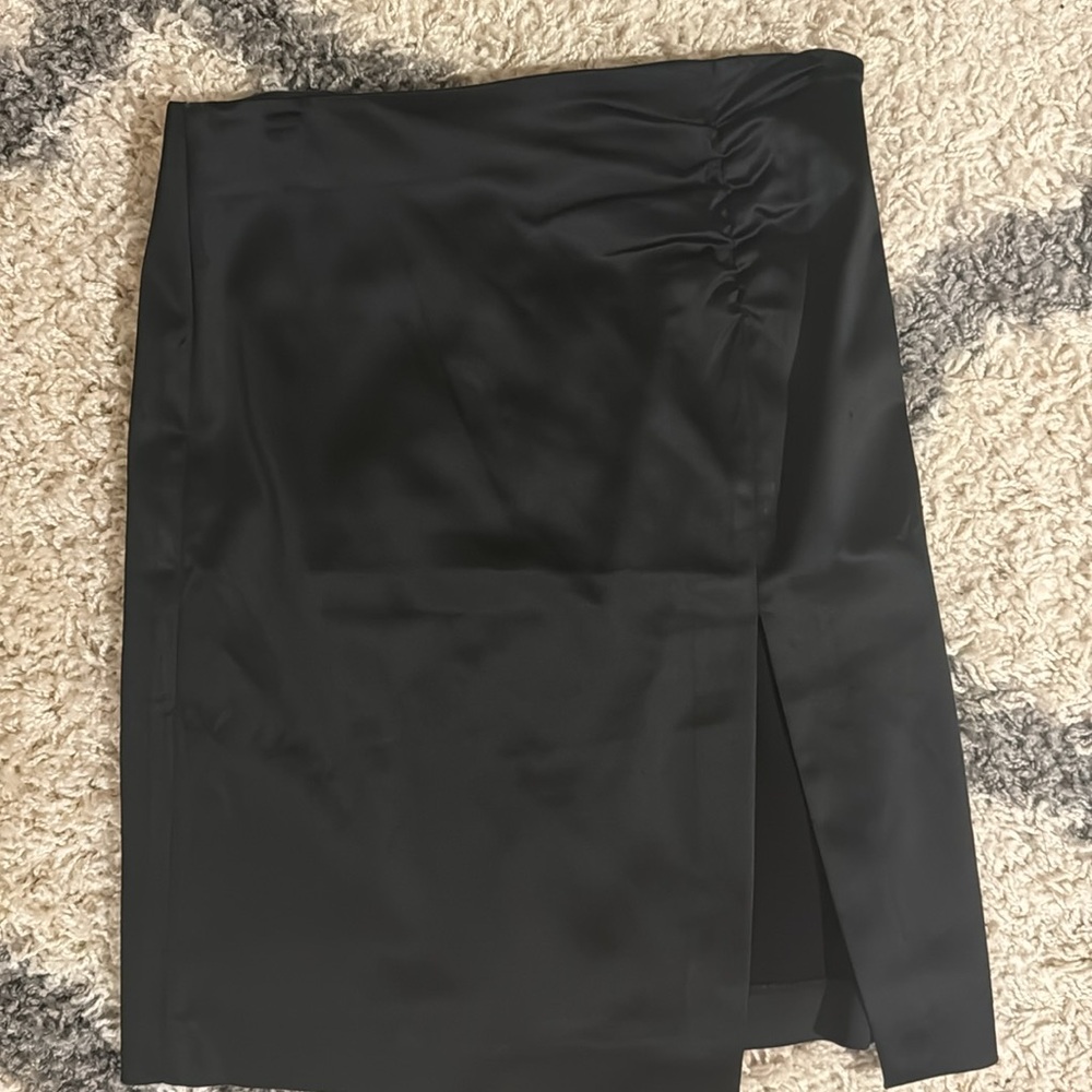 Pre-loved sexy Bebe skirt (satin feel) see pic of tag with actual material.